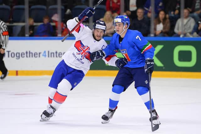 CAPTAIN FANTASTIC: Jonathan Phillips battles with Italy's Marco Zanetti in Nottingham last week. Picture courtesy of Dean Woolley/Ice Hockey UK Media