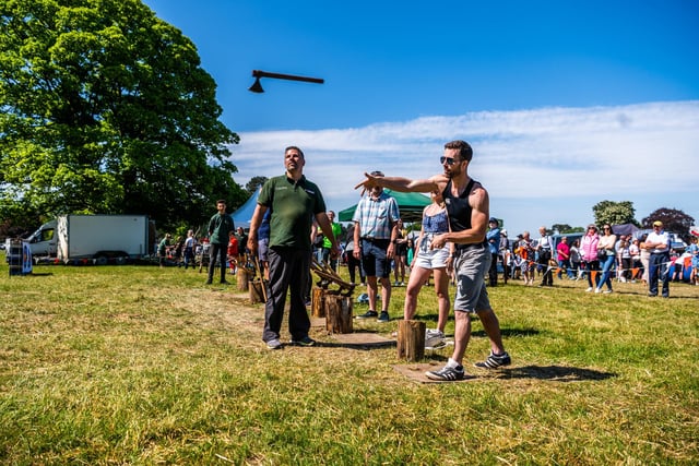 Visitors having ago at hand Axe Throwing at the show. Picture By Yorkshire Post Photographer,  James Hardisty.