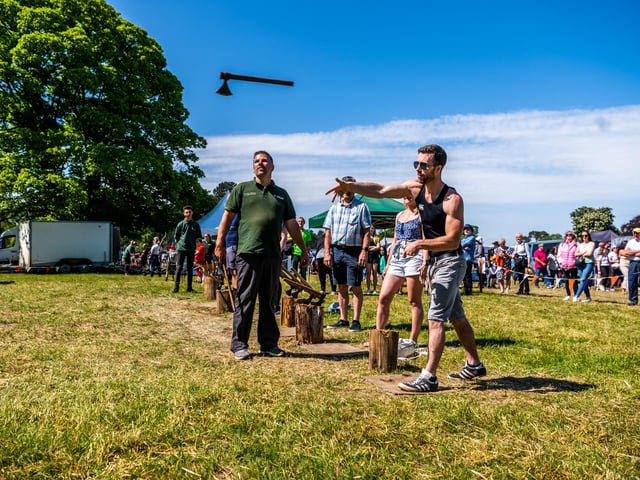 Visitors having ago at hand Axe Throwing at the show. Picture By Yorkshire Post Photographer, James Hardisty.
