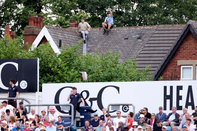 Fans watch from any vantage point possible. Photo by Richard Heathcote/Getty Images.
