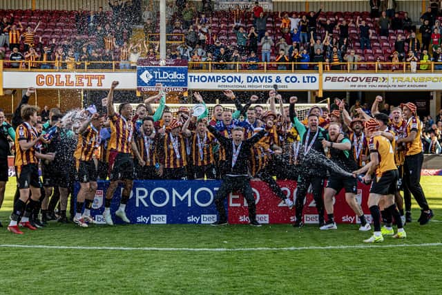 Bradford City players and staff celebrate promotion following a last-gasp 1-0 win over Fleetwood. Photo: Tony Johnson.