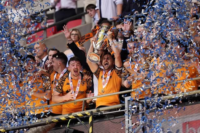 Hull City's Lewis Coyle lifts the trophy after winning promotion to the Premier League following the Sky Bet Championship play-off final against Middlesbrough at Wembley Stadium, London. Picture: Jordan Pettitt/PA Wire.