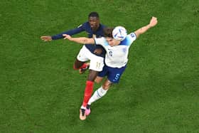 Ousmane Dembele of France and John Stones of England compete for the ball during the FIFA World Cup Qatar 2022 quarter final. (Picture: Matthias Hangst/Getty Images)