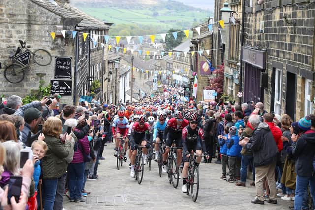 Riders climb a hill in Haworth during stage four of the Tour de Yorkshire in 2019