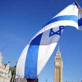 An Israeli flag at a vigil at Parliament Square in London. PIC: James Manning/PA Wire