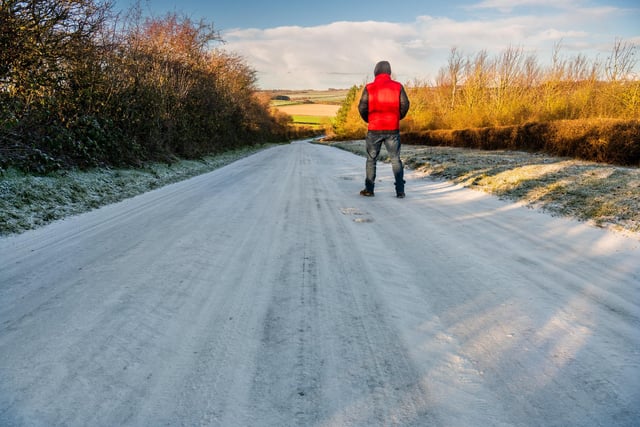 A man stops to admire the lightly snow covered Thwing Road between Kilham and Thwing.