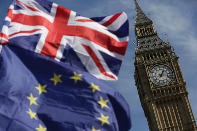 An EU flag and a Union Jack outside the Houses of Parliament. PIC: DANIEL LEAL-OLIVAS/AFP via Getty Images
