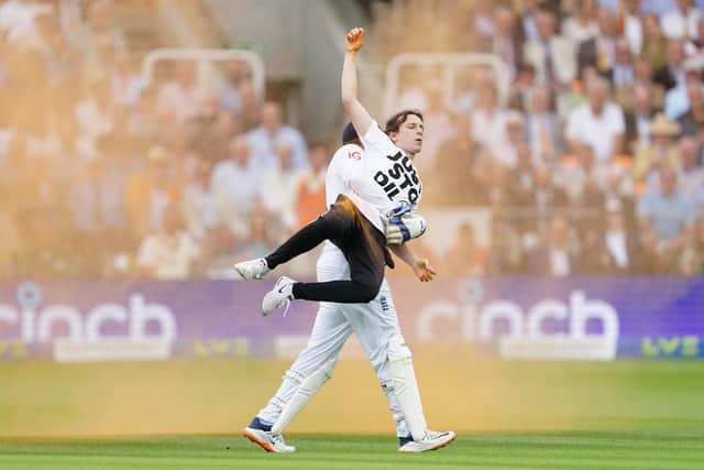 England's Johnny Bairstow carrying a Just Stop Oil protester off the pitch  during day one of the second Ashes test match at Lord's, London.Photo credit: Mike Egerton/PA Wire.