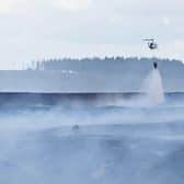 Emergency services battle to contain a giant blaze burning through Langdale Moor for three weeks. SWNS