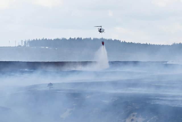 Emergency services battle to contain a giant blaze burning through Langdale Moor for three weeks. SWNS