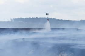 Emergency services battle to contain a giant blaze burning through Langdale Moor for three weeks. SWNS
