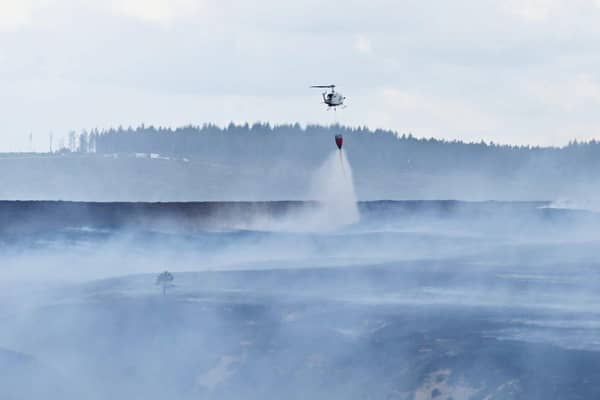 Emergency services battle to contain a giant blaze burning through Langdale Moor for three weeks. SWNS
