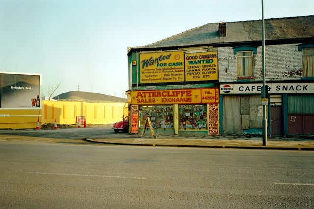 The 'buy and sell shop' trades between a boarded-up snack bar and a demolition site.