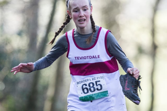 Teviotdale Harrier Jessica Smith carrying on despite losing a shoe in the mud, finishing as 20th girl in 14:04