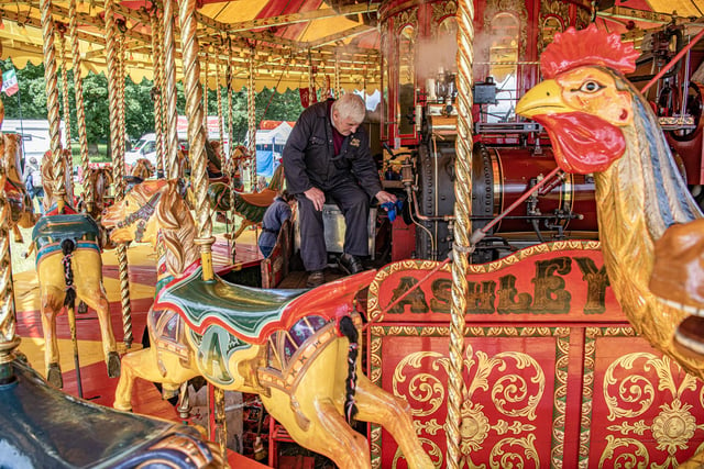Jack Ashley stokes up his steam powered carousel.