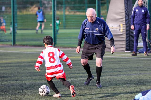 Frank Foster, 89, refereeing under 7's during their football game at Goodwin Sports Centre in Sheffield