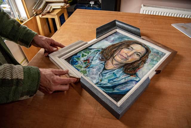 Joe Doldon,  Sheffield's only certified fine art picture framer with a selection of mouldings to frame a self portrait by Sarah Coleman, photographed for The Yorkshire Post Magazine by Tony Johnson. His workshop is in his home, a terraced house in the city.