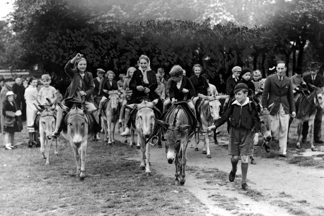 August Bank Holiday during war-time. Children are enjoying donkey rides at Roundhay Park, provided as 'seaside' entertainment. Travel was restricted, many coastal resorts were off limits. The Government encouraged local councils to provide entertainment for children to have 'stay-at-home' holidays.