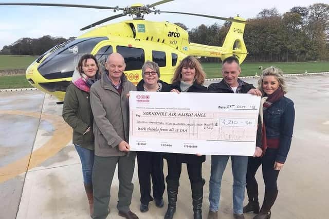 Caroline (centre right) presenting funds to Yorkshire Air Ambulance.