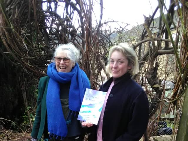 India, on the right, with the author Pam Pottinger, shows off her new book