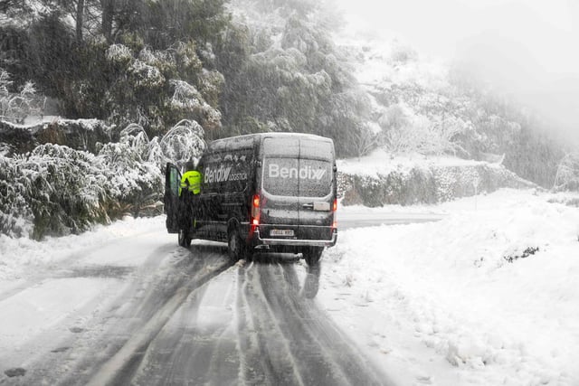 A van stops after skidding on a snow-covered road close to the mountain village of Valldemossa on the Spanish Balearic island of Mallorca, on February 27, 2023. (Photo by JAIME REINA/AFP via Getty Images)
