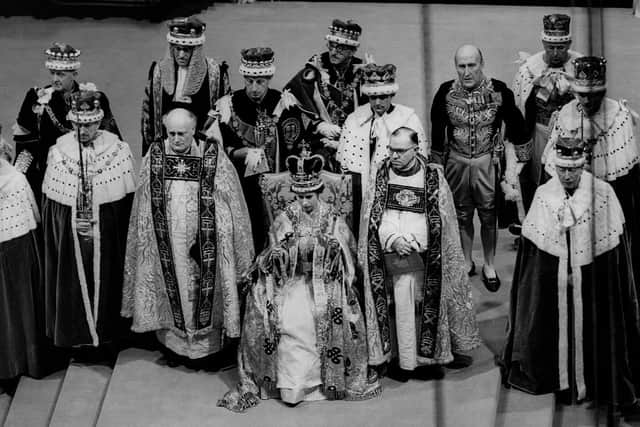 Queen Elizabeth II sits on a throne during her coronation in Westminster Abbey in 1953. (Pic credit: Central Press Photo / AFP via Getty Images)