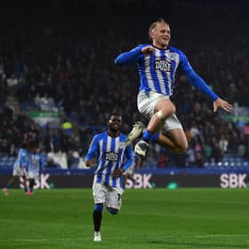 Huddersfield Town striker Joe Taylor leaps high after scoring his side's third goal against former club Peterborough United on Tuesday night. Picture: Jonathan Gawthorpe