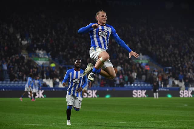 Huddersfield Town striker Joe Taylor leaps high after scoring his side's third goal against former club Peterborough United on Tuesday night. Picture: Jonathan Gawthorpe