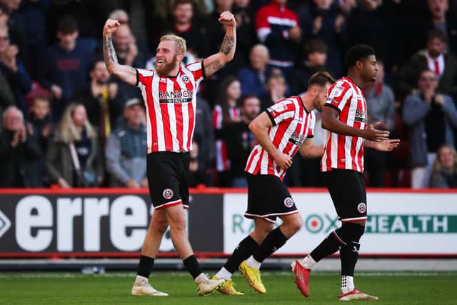 Sheffield United's Oli McBurnie (left) celebrates scoring their side's first goal of the game during the Sky Bet Championship match at Bramall Lane. Picture: Press Association