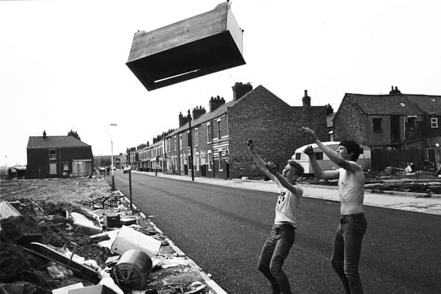 Rag and Bone Man George Norris and his mate Glenn Collins smashes a wardrobe that has no resale value at a land housing clearance site in Hull 1983.   Picture by Russell Boyce 
