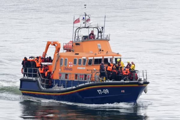 A group of people thought to be migrants are brought in to Dover. PIC: Gareth Fuller/PA Wire