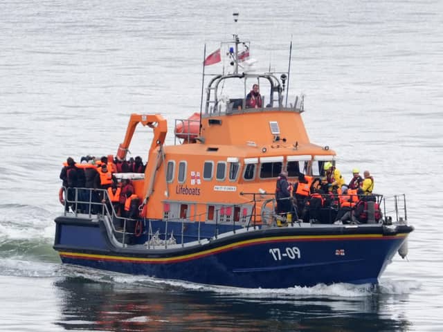 A group of people thought to be migrants are brought in to Dover. PIC: Gareth Fuller/PA Wire