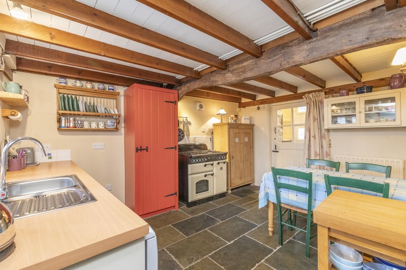 The kitchen is full of period features including beams