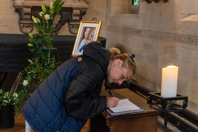 A member of the public signs the book of condolence for HRH Queen Elizabeth at Bradford Cathedral paying respect following her death on thursday.
9 September 2022. Picture Bruce Rollinson
