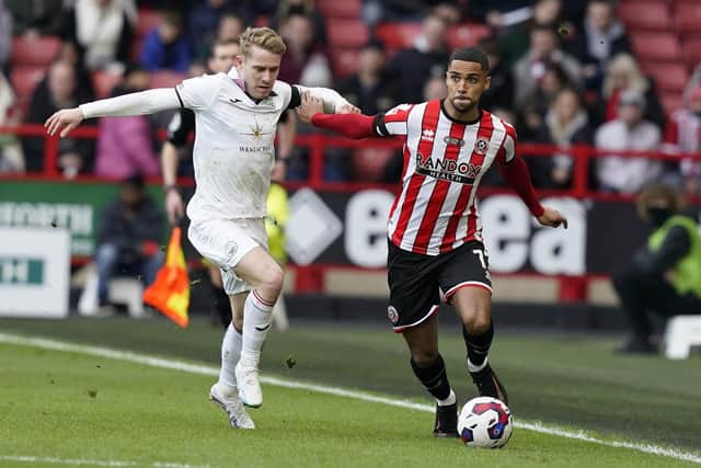 Max Lowe of Sheffield Utd (R) is challenged by Ollie Cooper of Swansea City (Picture: Andrew Yates / Sportimage)
