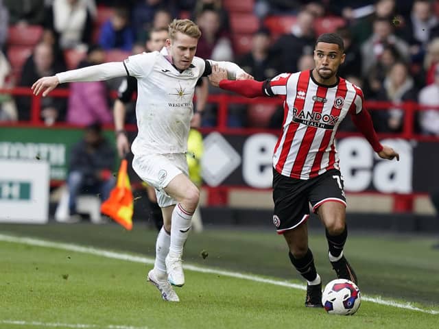 Max Lowe of Sheffield Utd (R) is challenged by Ollie Cooper of Swansea City (Picture: Andrew Yates / Sportimage)