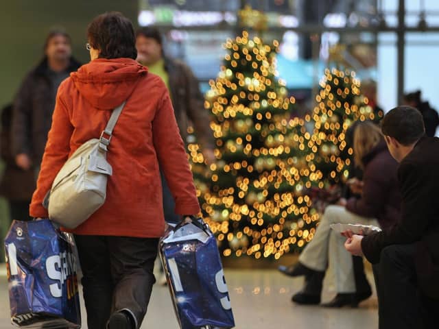 A woman carries shopping bags through a shopping centre near Christmas time. PIC: Sean Gallup/Getty Images