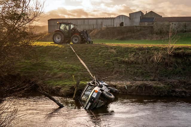 The recovered vehicle being removed from the River Esk after three men, trapped in a submerged 4×4 vehicle, were "swept away" as they attempted to cross the river. Emergency services including police, ambulance and a helicopter attended shortly before midday on Thursday December 28. Photo credit should read: Danny Lawson/PA Wire