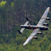 A Lancaster bomber flies over Derwent Reservoir in Derbyshire, England on May 16, 2013, as part of events marking the 70th Anniversary of an air-raid on three dams in Germany's Ruhr Valley  by a team of airmen dubbed the "Dambusters". (Photo credit should read ANDREW YATES/AFP/Getty Images)