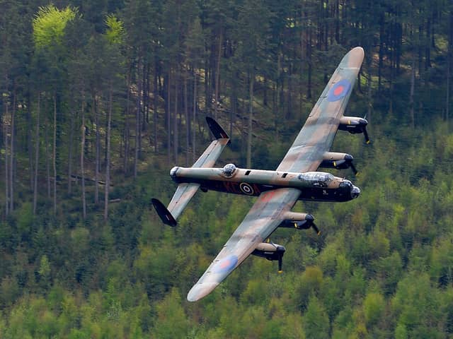 A Lancaster bomber flies over Derwent Reservoir in Derbyshire, England on May 16, 2013, as part of events marking the 70th Anniversary of an air-raid on three dams in Germany's Ruhr Valley  by a team of airmen dubbed the "Dambusters". (Photo credit should read ANDREW YATES/AFP/Getty Images)