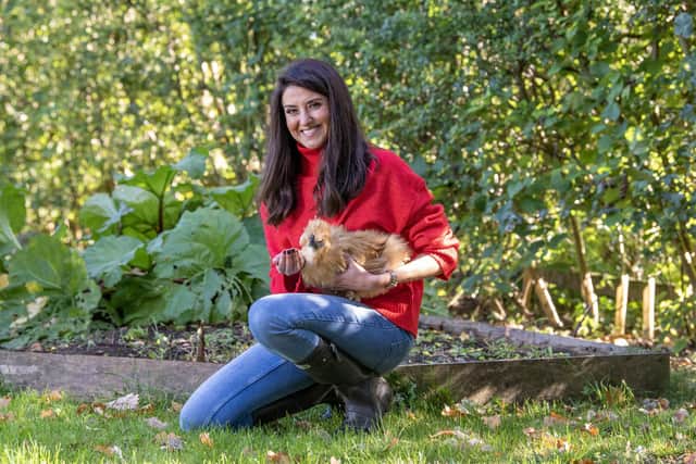 Amy with Pompom. "She is a silkie bantam, the others are pekin bantams. We incubated and hatched them in April and this week they started laying. All that pampering has finally paid off." Amy wears red jumper, and jeans from M&S.