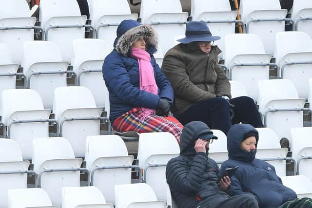 Spectators wrap up against the cold weather on a bitterly cold day at the Riverside. Photo by Stu Forster/Getty Images.