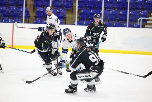DERBY DUEL: Sheffield Steeldogs' Alex Graham (#21) battles with Hull Seahawks's Nathan Salem in Tuesday's NIHL National clash at Ice Sheffield. Picture: Peter Best/Steeldogs Media