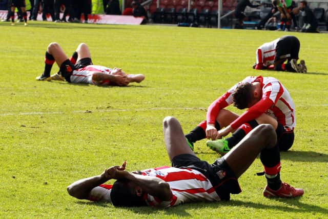 Sliding doors moment: Brentford players dejected after missing out on promotion to Doncaster Rovers. Now look at the two clubs (Picture: PA)