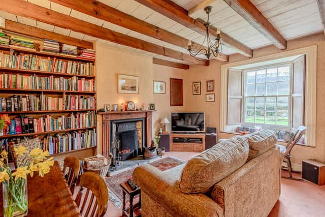 A cosy sitting room with a real fire and fabulous views