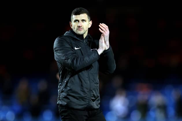 PETERBOROUGH, ENGLAND - JANUARY 28: John Mousinho manager of Portsmouth applauds after the Sky Bet League One between Peterborough United and Portsmouth at London Road Stadium on January 28, 2023 in Peterborough, England. (Photo by Catherine Ivill/Getty Images)