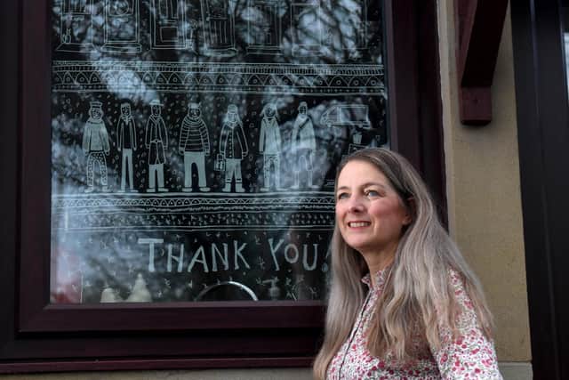 Amanda Dannells-Bewley with her window mural at her home in Ilkley.