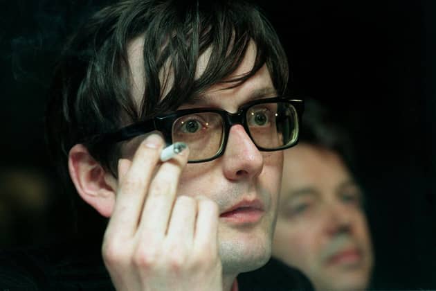 Pulp singer Jarvis Cocker pauses for a cigarette during a press conference following the Metropolitan Police's decision not to take any action against him following his outburst at the Brit Awards when he leapt onto the stage during a performance by American superstar Michael Jackson. Picture: Stefan Rousseau/PA.