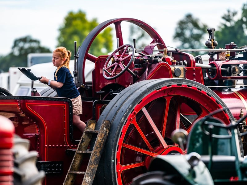 Pictured Lily Appleby, aged 6, of Pickering, pretending shovel coal on her grandfathers 1901 - 7HP Marshall Traction Engine. Picture: James Hardisty. Date: 6nd September 2026.