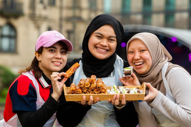 Lynda Z, Puteri Azhar, and Mahirah A. Rahman, from Zurul Malaysian Cafe on Glossop Road, Sheffield, with a seletion of Malaysian deserts on sale as part of the festival food celebrations.